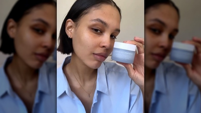 Nara Smith holding moisturizer