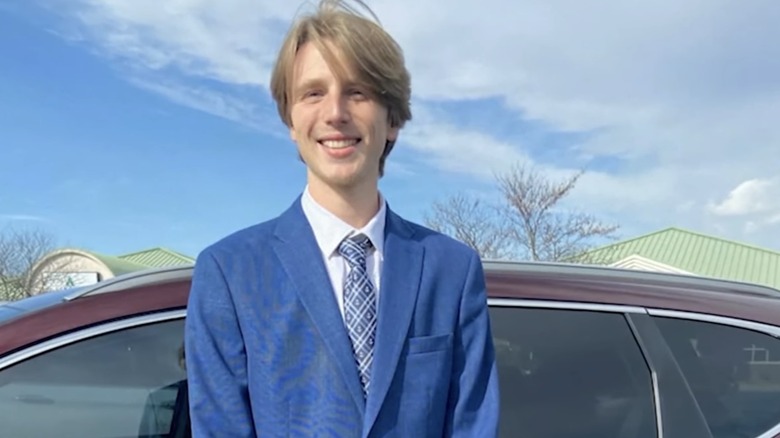 Riley Strain smiling next to car