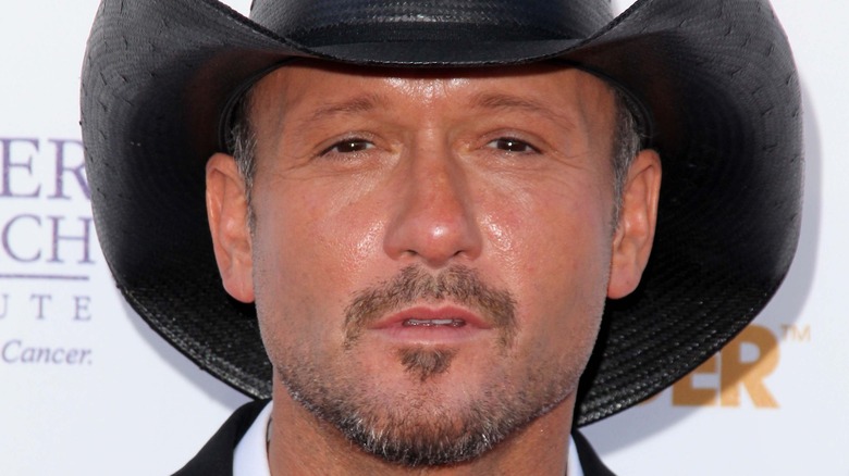 Tim McGraw wearing a black hat