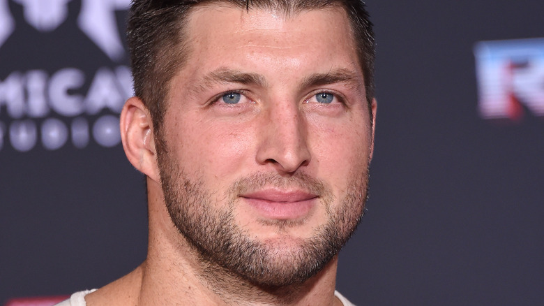 Tim Tebow smiles at an event