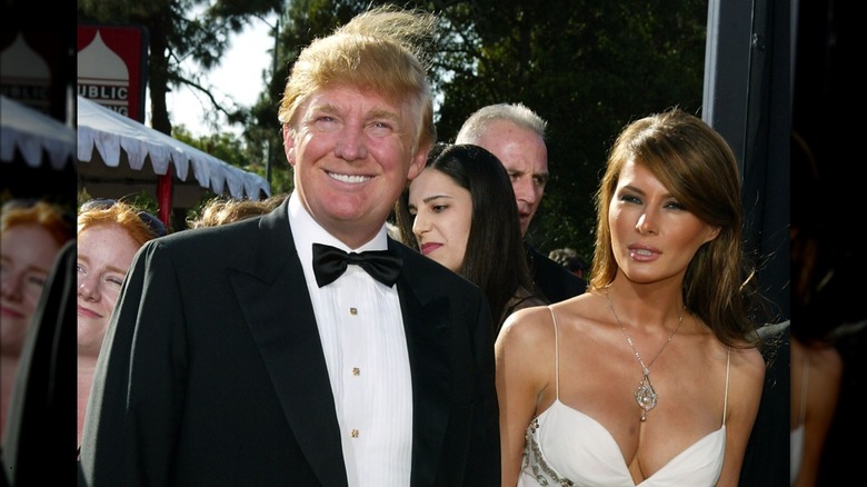 Donald Trump's hair blows up as he poses with Melania Trump at the 2004 Emmys