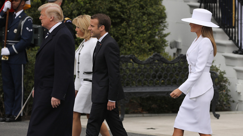 Donald Trump (L) and U.S. first lady Melania Trump (R) welcome French President Emmanuel Macron (2nd R) and his wife Brigitte to the White House during a state arrival ceremony April 24, 2018.