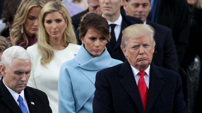 President Donald Trump and Vice President Mike Pence stand on the West Front of the U.S. Capitol on January 20, 2017, with Melania Trump behind them.