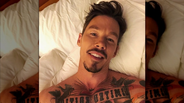 David Bromstad taking a selfie in bed.