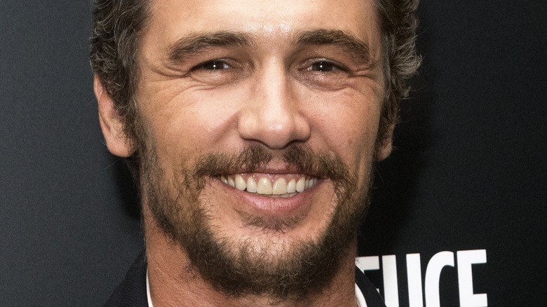 James Franco, smiling, in suit