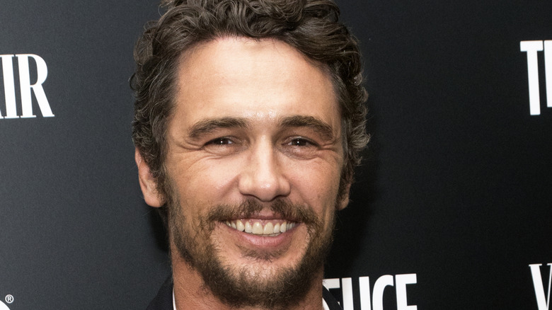 James Franco, smiling, in suit