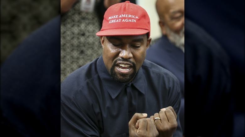 Ye West in a red MAGA hat