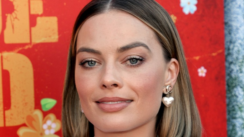 Margot Robbie smirking at camera