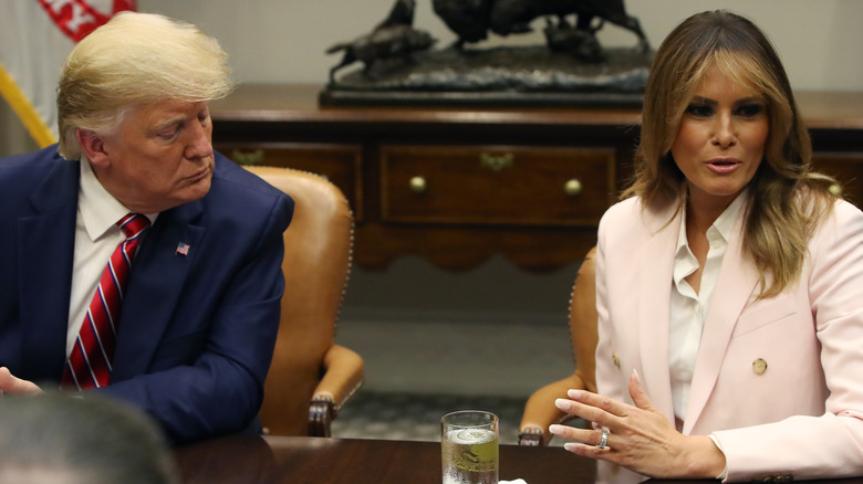 Melania Trump talking while Donald Trump listens