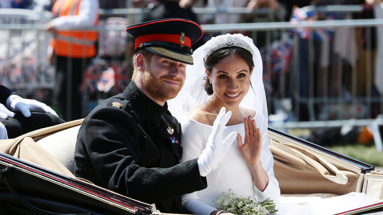 Prince Harry and Meghan Markle waving