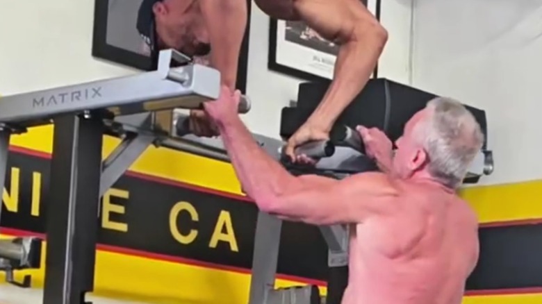 Robert F. Kennedy Jr. working out in the gym with a friend