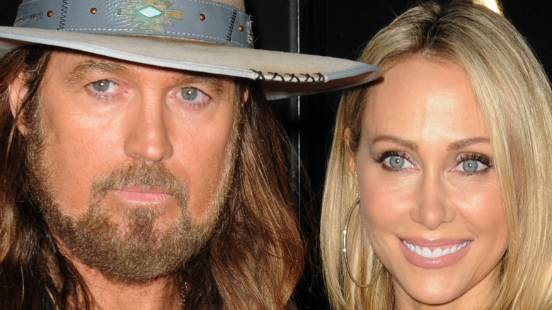 Tish and Billy Ray Cyrus pose side by side
