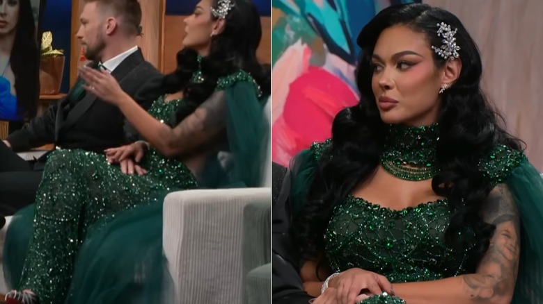 Amani Jlassi, wearing full makeup and an emerald outfit, gazing downward.