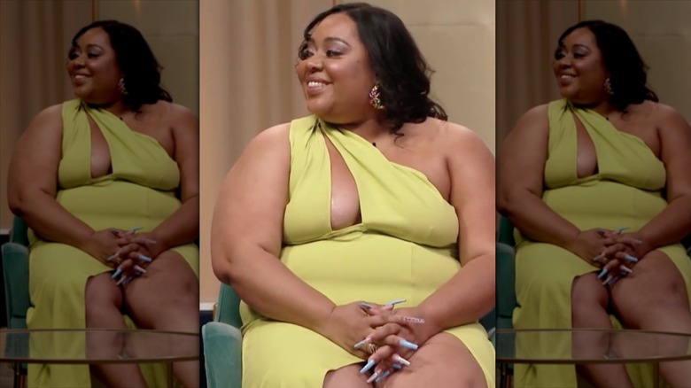 Shannon, in a lime-green-outfit, looks to the side while talking.