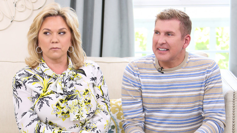 Julie and Todd Chrisley sitting on couch