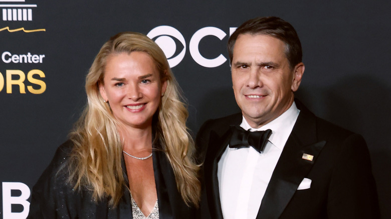 Todd Blanche and his wife Kristine smiling while posing on the red carpet together