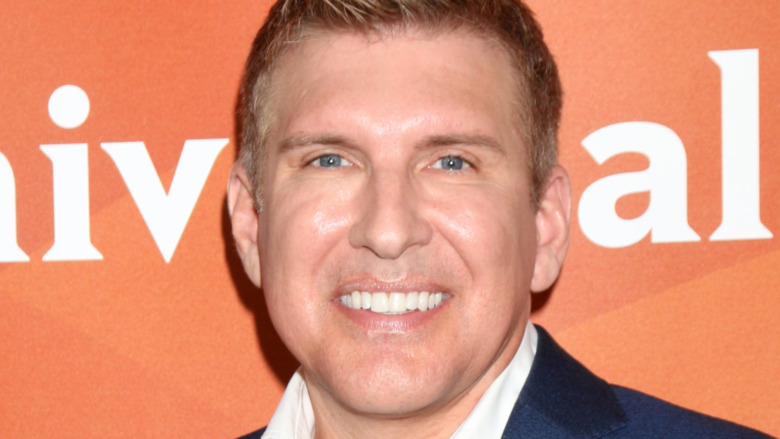 Todd Chrisley smiling at a red carpet event