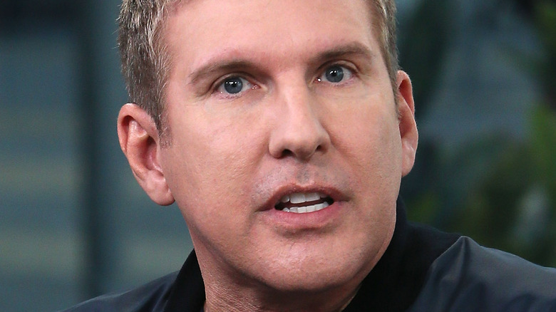 Todd Chrisley looking angry black jacket