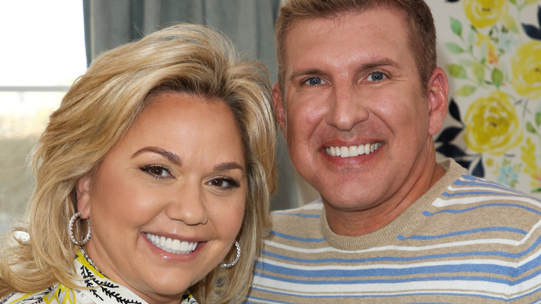 todd and julie chrisley posing for cameras 