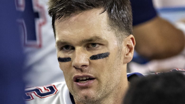 Tom Brady wearing eye black and football gear