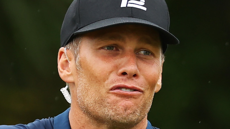 Tom Brady makes a perplexed face during golf