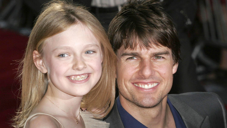 Dakota Fanning and Tom Cruise smiling