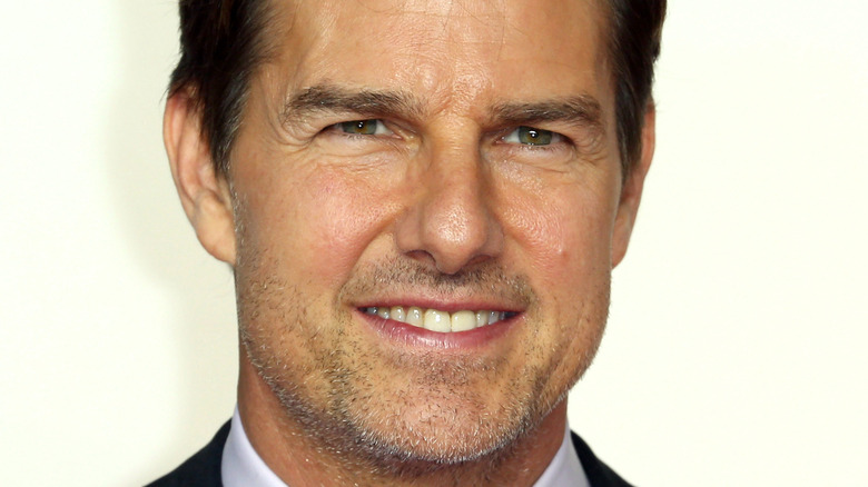 Tom Cruise smiling with white background