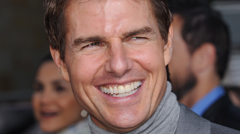 Tom Cruise smiling on a red carpet