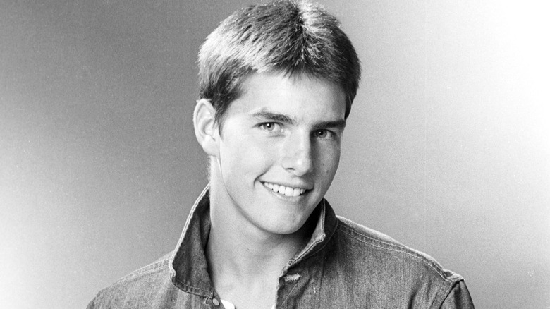 Tom cruise posing and smiling in 1980 