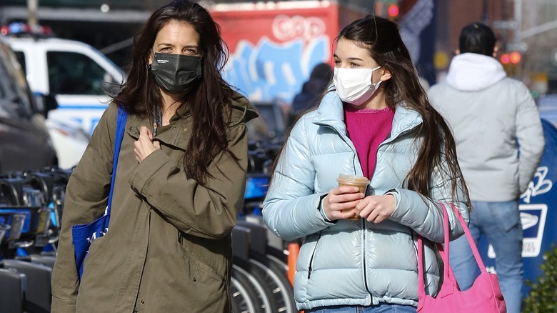Katie Holmes and Suri Cruise wearing masks