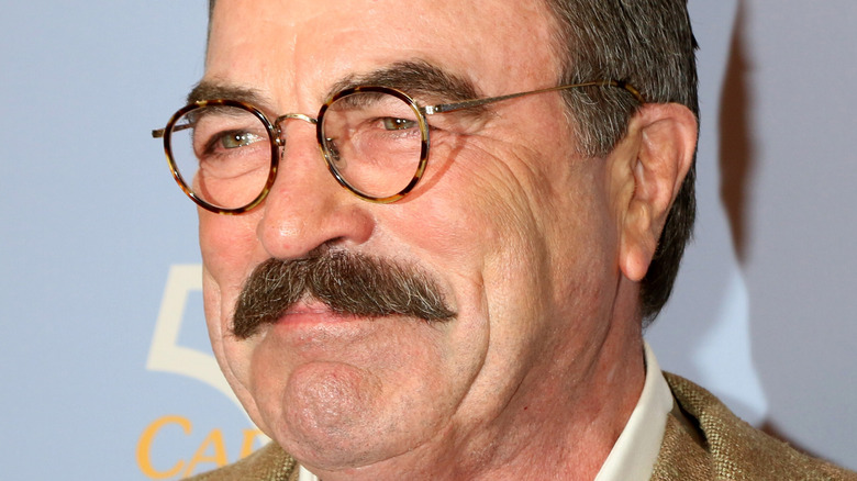 Tom Selleck smiling in glasses