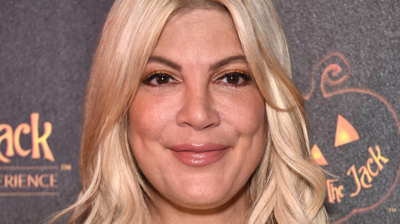 Tori Spelling smiles