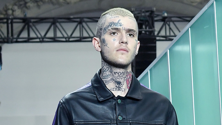 Lil Peep at a fashion show wearing black leather outfit