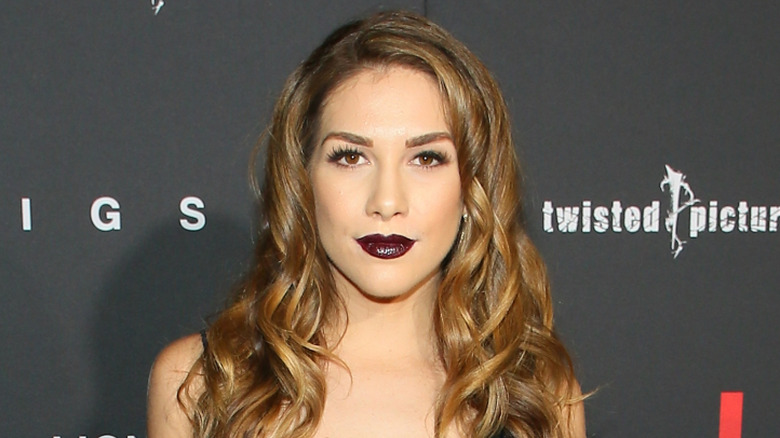 Allison Holker wearing a black strappy dress and black lipstick