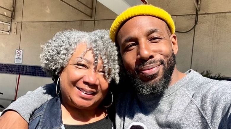 Connie Boss Alexander wearing a denim jacket and black shirt with Stephen "tWitch" Boss wearing a grey sweatshirt and yellow beanie