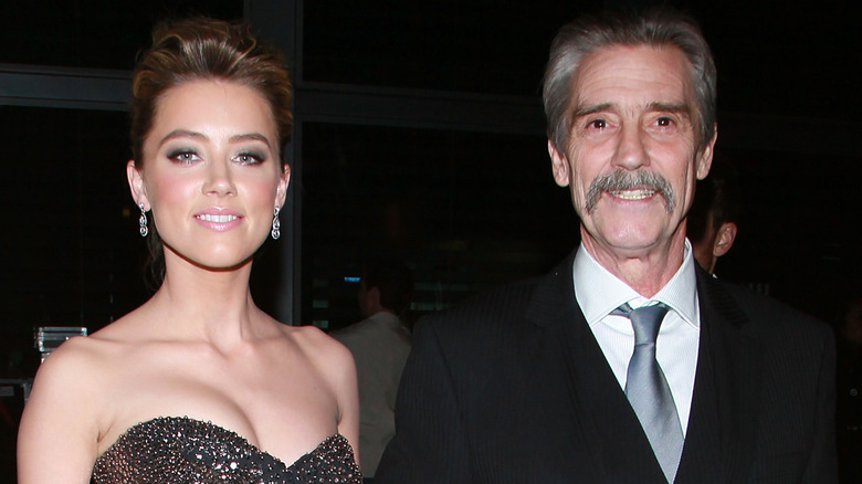 Amber Heard posing with her dad 