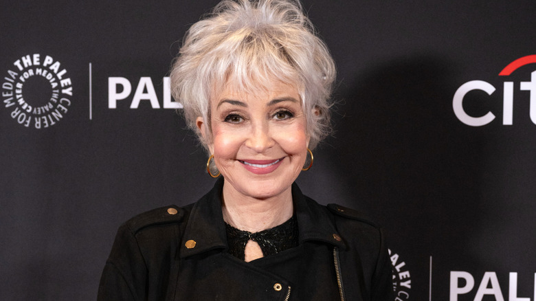 Annie Potts posing in a black jacket