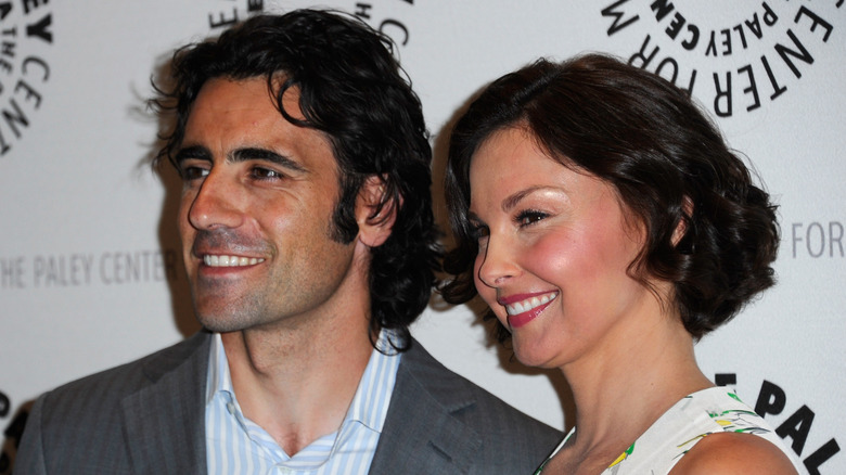 Dario Franchitti, Ashley Judd smiling while posing at the Paley Center