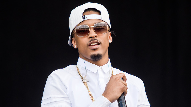 August Alsina standing on stage