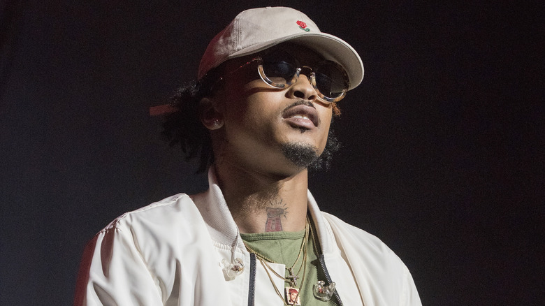 August Alsina standing on stage