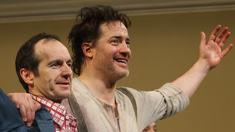 Brendan Fraser and Denis O'Hare arm in arm