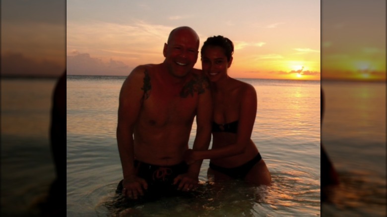 Bruce and Emma Willis posing together in the sea.