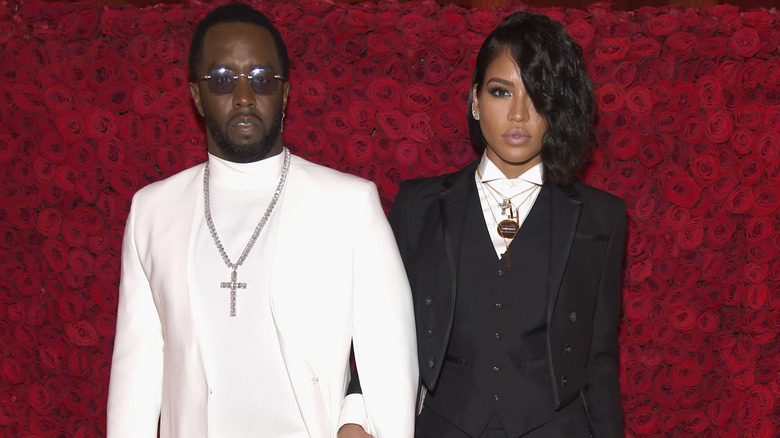 Diddy and Cassie wearing matching suits
