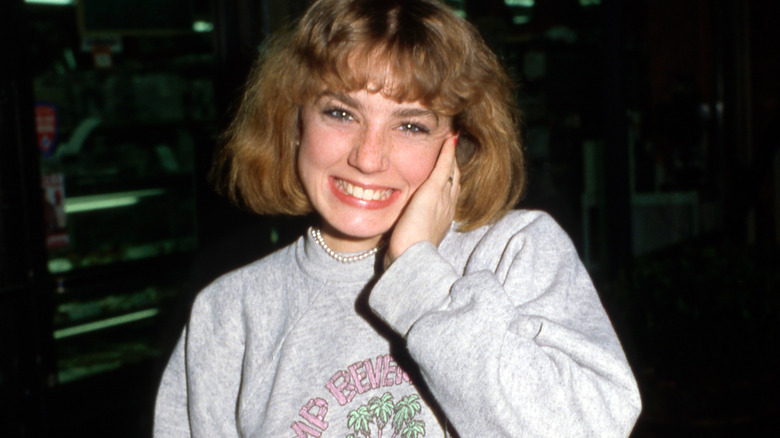 Dana Plato holding face smiling