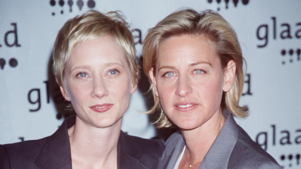 Anne Heche, Ellen DeGeneres posing together, both with serious expressions