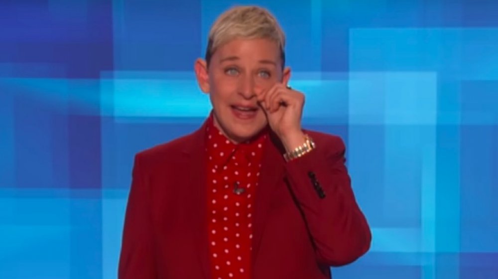 Ellen DeGeneres in a red suit, tearing up on The Ellen DeGeneres Show