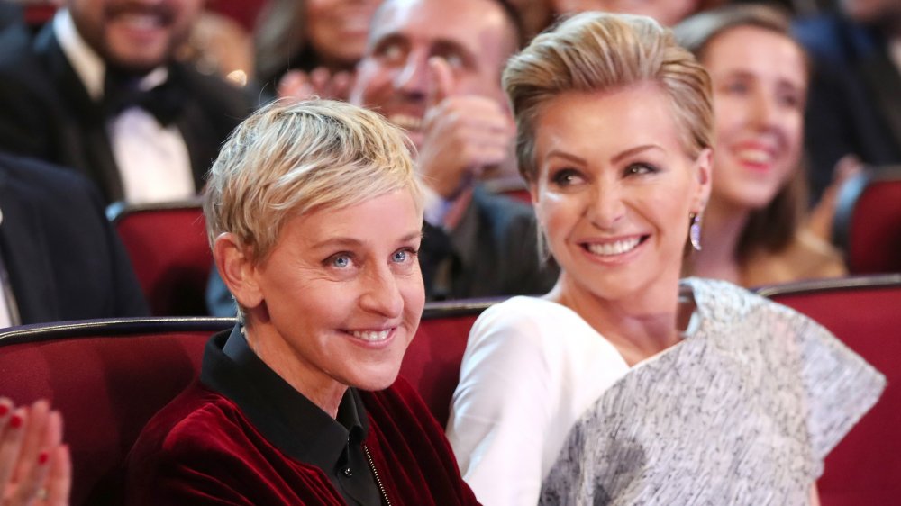 Ellen DeGeneres, Portia de Rossi smiling in the audience of an awards show