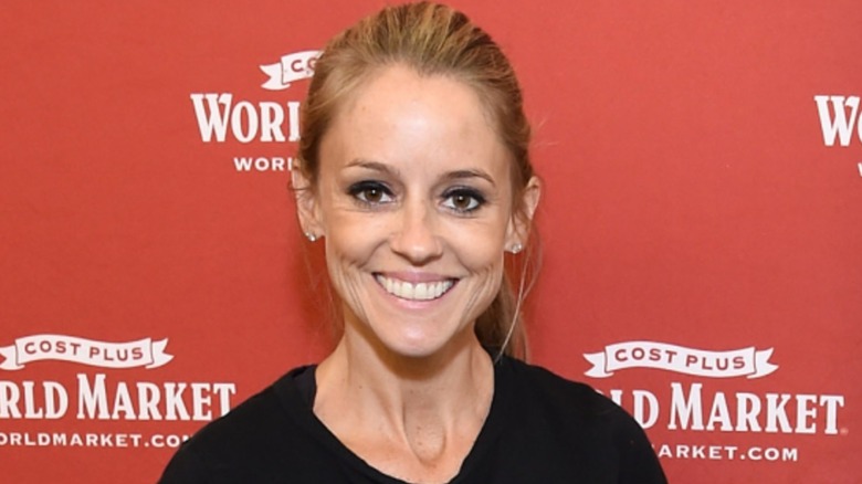 Wearing a black top, Nicole Curtis looks into the camera while all smiles.