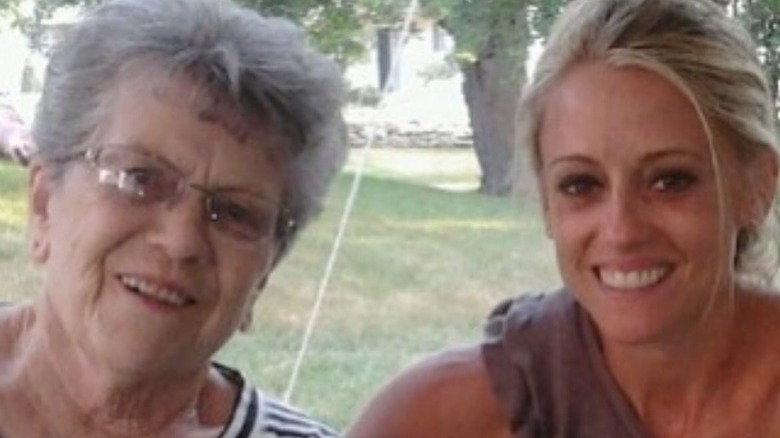 Nicole Curtis smiles as she hugs her grandma, who is leaning toward her.