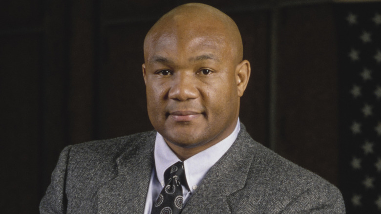 George Foreman posing for cameras in gray wool suit